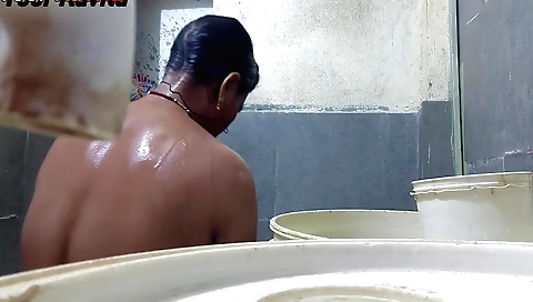 Indian girl in a bath is getting naked in a bathroom