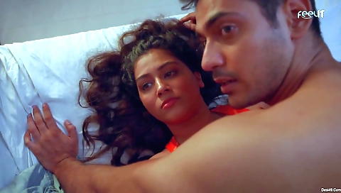 Brunette in a black dress and black stockings riding a bike